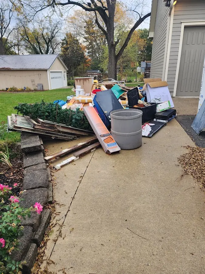 Dumpster being loaded with debris for Roofing Dumpster Rental in Ankeny